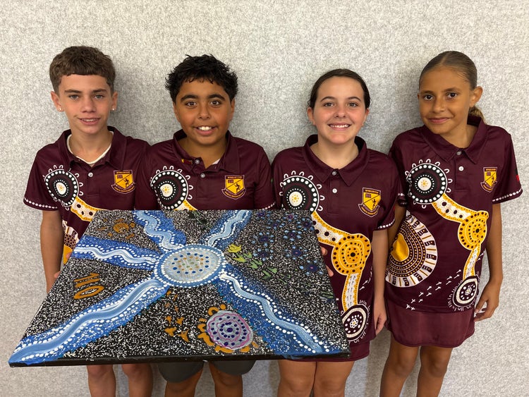 An image of four students holding their collaborative artwork