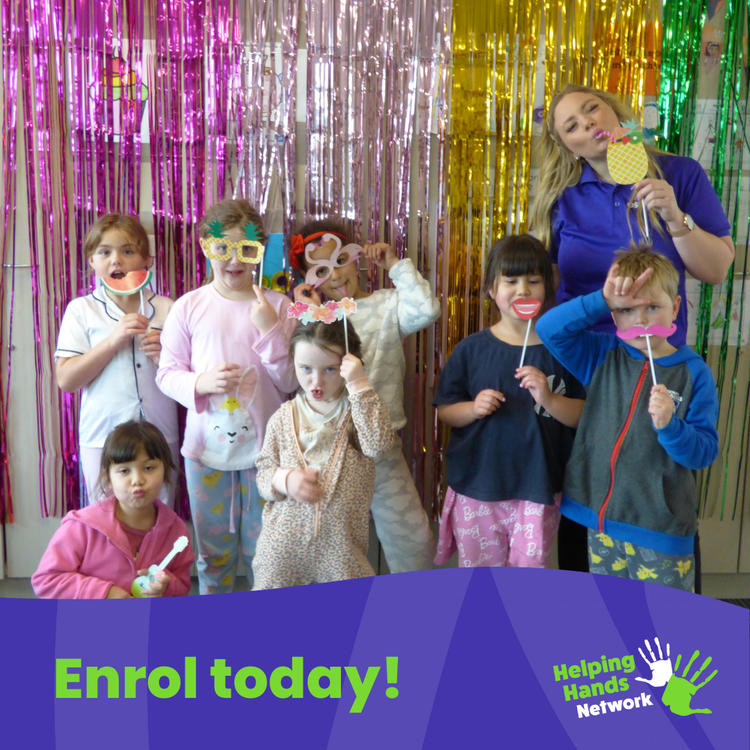 An image of an educator and children infront of a rainbow coloured tinsel banner